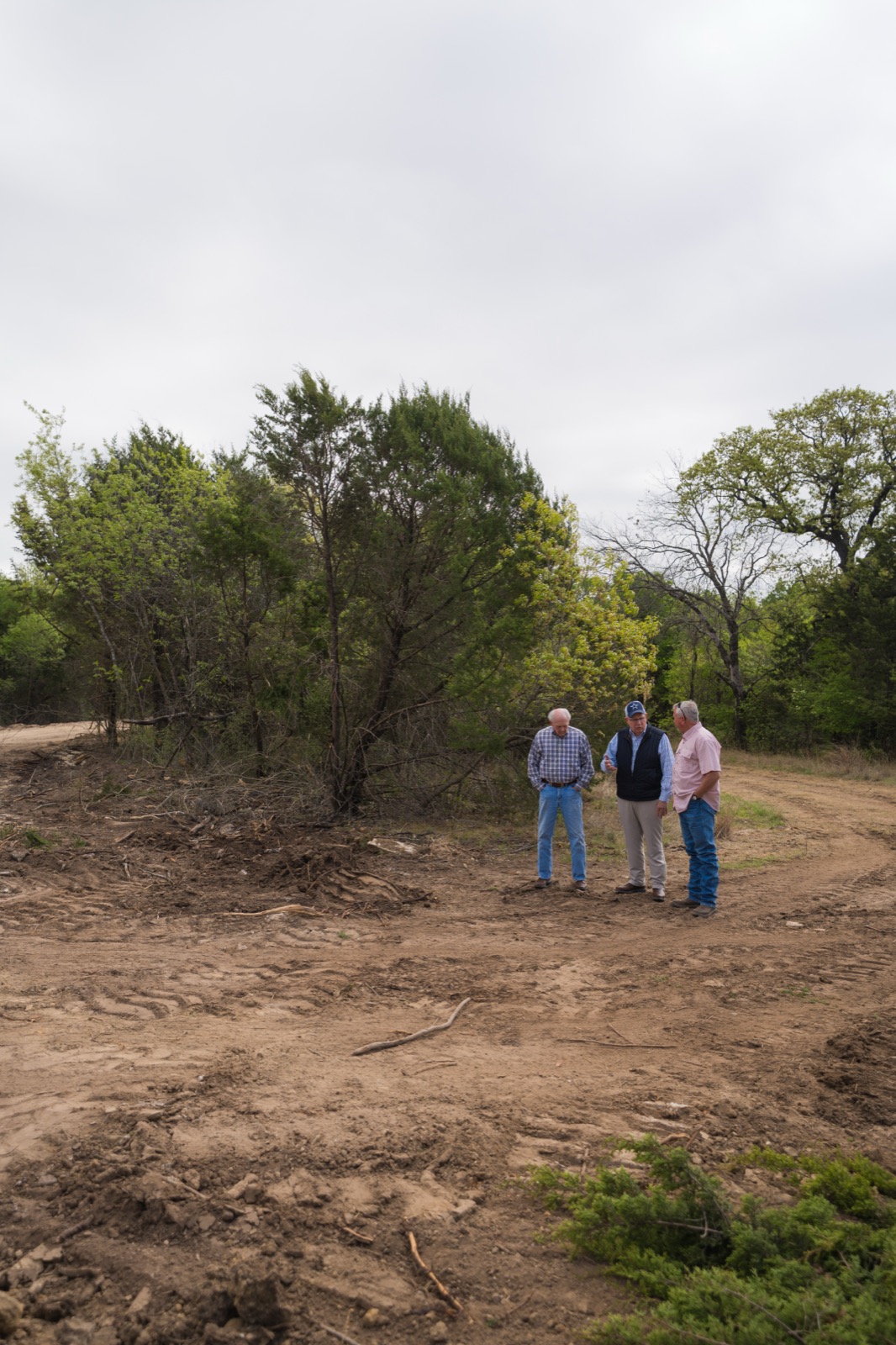 Westbrook reviewing the project on site with the owner, on cleared ground.